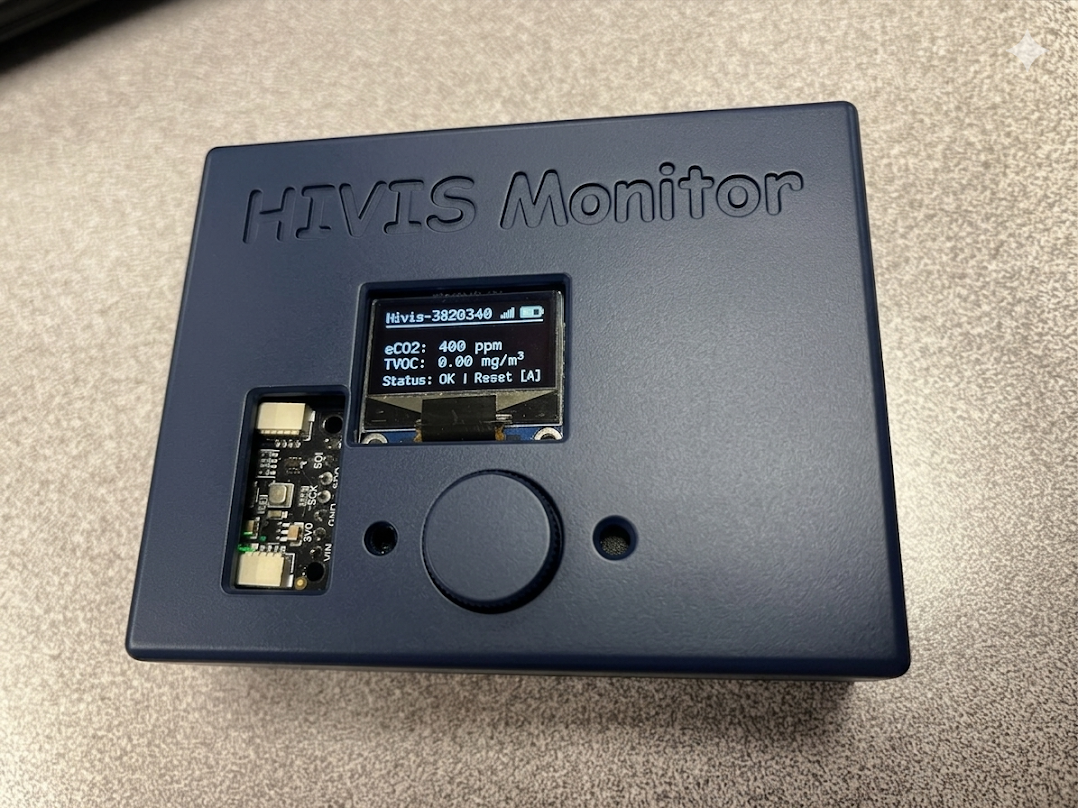 V1 with battery attached showing live OLED readings